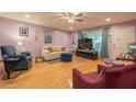 Inviting living room with hardwood floors, ceiling fan, and comfortable seating at 9441 W Long Hills Dr, Sun City, AZ 85351