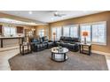 Open living area with comfortable seating, bright windows, and views to the kitchen at 9952 W Jessie Ln, Peoria, AZ 85383