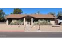 Inviting one-story home with a brick facade and minimalist desert landscaping at 11406 W Montana Ave, Youngtown, AZ 85363