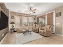 Bright living room featuring neutral tones, a ceiling fan, and tile flooring at 1805 E Atole Pl, Queen Creek, AZ 85140