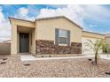 Charming single-story home with stone accents, desert landscaping, and a welcoming entrance at 18400 E Donato Dr, Gold Canyon, AZ 85118