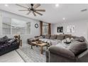 Cozy living room with a large sectional sofa, ceiling fan, and lots of natural light at 18400 E Donato Dr, Gold Canyon, AZ 85118