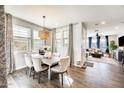 Inviting dining room with wood floors, a chandelier, and large windows overlooking a peaceful view at 1950 E Lantana Dr, Chandler, AZ 85286