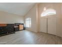 Bright living area showcasing tile floors, vaulted ceiling, neutral colors, and a double door entry at 1980 N Santa Fe Ct, Casa Grande, AZ 85122