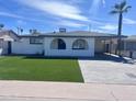 Charming single-story home with a well-maintained lawn and a brick driveway at 2031 E Don Carlos Ave, Tempe, AZ 85281