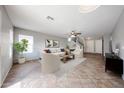 Bright living room featuring neutral tones, tile flooring, and ample natural light at 22473 W Woodlands Ave, Buckeye, AZ 85326