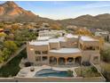 Aerial view of the desert home showcasing the pool, patio, and mountain scenery at 24019 N 112Th Pl, Scottsdale, AZ 85255