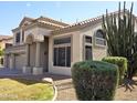 Gorgeous home with tile roof, arched entryway, and desert landscaping is sure to impress any visitor at 2925 E Cathy E Dr, Gilbert, AZ 85296