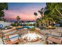 Outdoor seating around fire pit next to a pool with lake access at 3441 S Camellia Pl, Chandler, AZ 85248