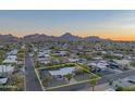 Expansive aerial view showcases the single-story home's location with mountain views and mature trees at 3531 E Onyx Ave, Phoenix, AZ 85028