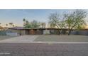 Charming single-story home featuring a carport, brick facade, desert landscaping, and a unique privacy screen at 3531 E Onyx Ave, Phoenix, AZ 85028