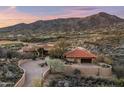 Stunning aerial view of a desert home with a red tile roof and mountain backdrop at 40947 N 107Th Pl, Scottsdale, AZ 85262