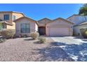 Charming single-story home featuring a well-maintained yard with desert landscaping and a two car garage at 42297 W Lunar St, Maricopa, AZ 85138