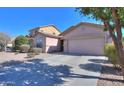 Charming single-story home featuring a well-maintained yard with desert landscaping and a two car garage at 42297 W Lunar St, Maricopa, AZ 85138