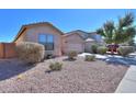 Well-maintained desert landscape in the front yard of a single-story home with a two-car garage at 42297 W Lunar St, Maricopa, AZ 85138