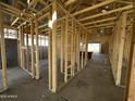 Interior framing of a new home, showing the exposed wood and concrete slab foundation at 4262 E Brook Lynn Pl, San Tan Valley, AZ 85140