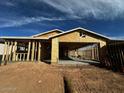 New home under construction, featuring a wood frame and garage, set against a bright blue sky at 4262 E Brook Lynn Pl, San Tan Valley, AZ 85140