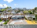 Beautiful aerial view of a well-maintained property with mature trees and stunning city views in the distance at 443 W Mulberry Dr, Phoenix, AZ 85013