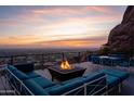 Relaxing outdoor lounge area with comfortable seating, fire pit, and stunning city views at 4959 E Red Rock Dr, Phoenix, AZ 85018