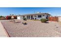 Attractive single-story home featuring low maintenance rock landscaping and colorful flower beds at 5526 E Cicero St, Mesa, AZ 85205