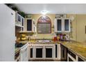 This home's kitchen features countertops with a stone effect and custom cabinets at 5848 W Gelding Dr, Glendale, AZ 85306