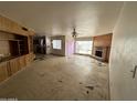 Open living room area featuring a fireplace, a built-in unit, and seamless access to the kitchen at 8124 N 45Th Ave, Glendale, AZ 85302