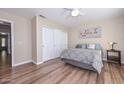 This cozy bedroom offers a large closet with sliding doors and wood floors at 8444 W Rockwood Dr, Peoria, AZ 85382