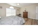 A bright bedroom with wood floors, window and a comfortable spot for relaxation at 8444 W Rockwood Dr, Peoria, AZ 85382