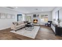 Inviting living room featuring a stone fireplace, plush seating, natural light, and wood-look floors at 8556 E Pecos Ln, Scottsdale, AZ 85250