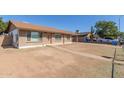 Home exterior showing the charming brick facade, covered parking, and low maintenance front yard at 8816 W Catalina Dr, Phoenix, AZ 85037