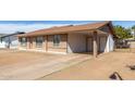 This home's exterior features a covered carport, brown brick, and plenty of parking space at 8816 W Catalina Dr, Phoenix, AZ 85037