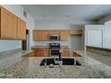 Bright kitchen featuring granite countertops, stainless steel appliances, and ample storage space in wood cabinetry at 934 E Carlise Rd, Phoenix, AZ 85086