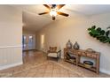 Spacious living room with tile flooring, a ceiling fan, and access to the backyard at 1001 W Montoya Ln, Phoenix, AZ 85027