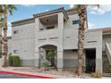 Exterior of a two-story condo with a private balcony, desert landscaping, and a red-painted curb at 10401 N Saguaro Blvd # 104, Fountain Hills, AZ 85268