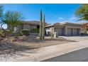 Desert home featuring native landscaping including a variety of mature cactus and desert plants at 10951 E Mirasol Cir, Scottsdale, AZ 85255
