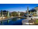 Beautiful pool with desert landscaping and an outdoor seating area perfect for relaxation at 10951 E Mirasol Cir, Scottsdale, AZ 85255