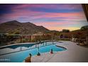 Inviting pool with picturesque desert mountain views and landscaped surroundings offering a private retreat at 12770 N 145Th Way, Scottsdale, AZ 85259