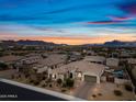 Stunning desert home with beautiful landscaping and a tile roof set against a vibrant sunset sky at 1319 N Chatsworth St, Mesa, AZ 85207