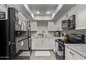 Well-lit kitchen featuring granite countertops, stainless steel appliances, and modern white cabinetry at 1340 N Recker Rd # 118, Mesa, AZ 85205