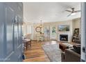 Inviting living room with hardwood floors, a fireplace, comfortable seating, and natural light, creating a cozy atmosphere at 15095 N Thompson Peak Pkwy # 1053, Scottsdale, AZ 85260