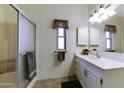 Bright bathroom with a shower, single vanity, and ample cabinet space at 17200 W Bell Rd # 1551, Surprise, AZ 85374