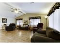 Spacious living room with vaulted ceilings, wood laminate flooring, and comfortable seating at 17200 W Bell Rd # 1551, Surprise, AZ 85374