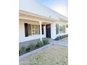 Charming home featuring a dark front door, black shutters, and manicured lawn at 1837 W Virginia Ave, Phoenix, AZ 85007