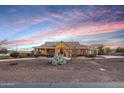 Charming single-story home boasting beautiful landscaping with desert plants and a circular driveway at 18919 W Verde Ln, Litchfield Park, AZ 85340