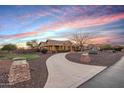 Beautiful house with a circular driveway, desert landscaping, and a lovely walkway at 18919 W Verde Ln, Litchfield Park, AZ 85340