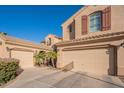 Exterior featuring a three-car garage with neutral paint and well maintained landscape at 1970 E Lafayette Ave, Gilbert, AZ 85298