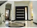Bright foyer featuring a modern door, tile floors, and views to the second level at 22339 N 77Th Way, Scottsdale, AZ 85255
