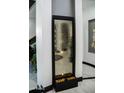 Modern water feature accenting the home's contemporary design, with views to the grand piano at 22339 N 77Th Way, Scottsdale, AZ 85255