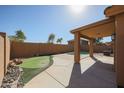 Backyard featuring a pool, desert landscaping, a putting green, and a covered patio at 22583 W Lasso Ln, Buckeye, AZ 85326