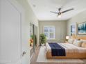 Cozy bedroom showcasing soft natural light, a ceiling fan, and mirrored closet at 295 N Rural Rd # 128, Chandler, AZ 85226